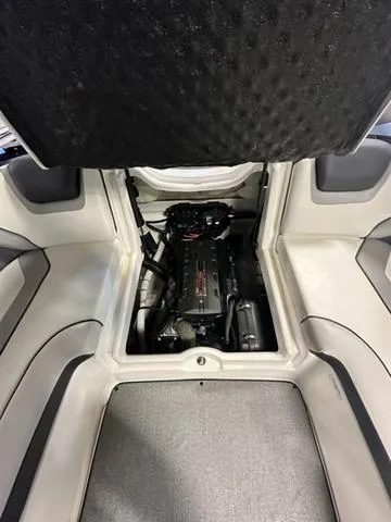 Slide: The Image of 2018 Yamaha Boats AR195 engine compartment with open hatch, showcasing interior design. - 12