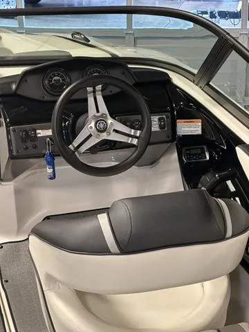 Slide: The Image of 2018 Yamaha Boats AR195 cockpit with steering wheel and dashboard controls. - 8
