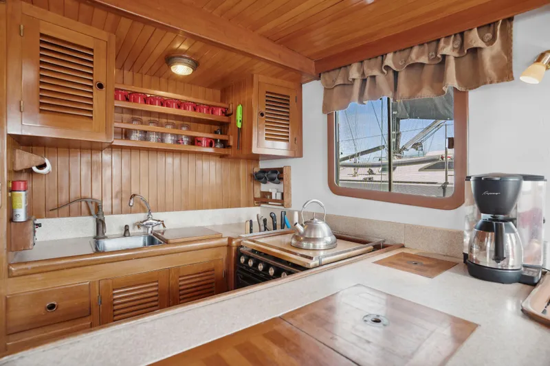 Slide: The Image of Wooden kitchen interior of 1987 Lord Nelson 37 Victory Tug with window view. - 11