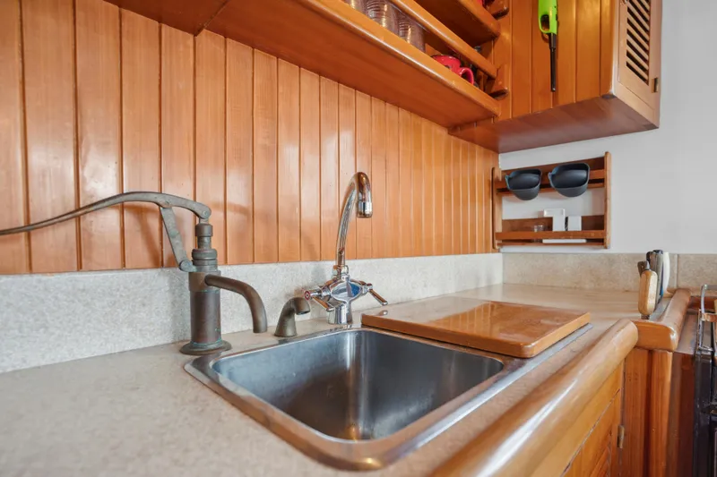 Slide: The Image of Wood-paneled kitchen in 1987 Lord Nelson 37 Victory Tug, featuring sink and countertop. - 12