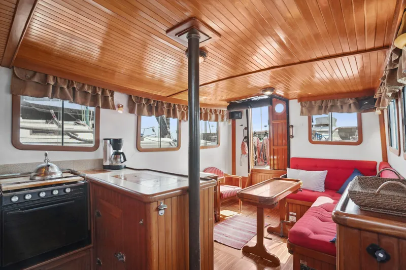 Slide: The Image of Cozy interior of 1987 Lord Nelson 37 Victory Tug with wood paneling and red seating. - 13