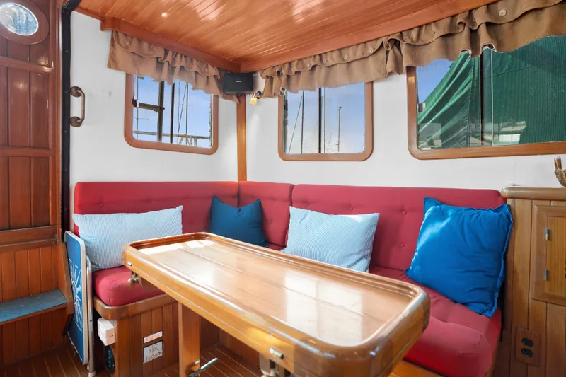 Slide: The Image of Cozy interior of 1987 Lord Nelson 37 Victory Tug with red seating and blue cushions. - 17