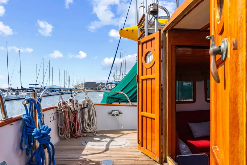 Slide: The Image of 1987 Lord Nelson 37 Victory Tug with open cabin door, docked at marina. - 18