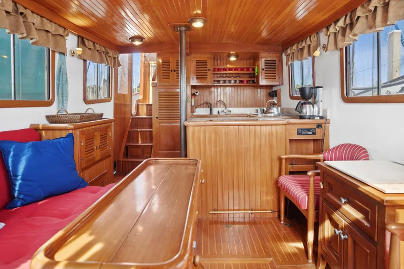 Slide: The Image of Interior of 1987 Lord Nelson 37 Victory Tug, featuring wood paneling and cozy seating. - 2