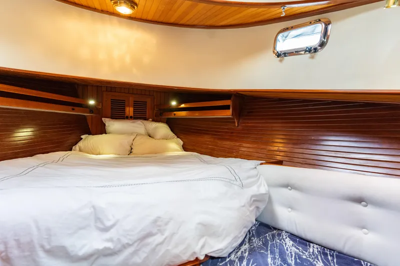 Slide: The Image of Cozy cabin interior of 1987 Lord Nelson 37 Victory Tug with wooden paneling and plush bedding. - 20