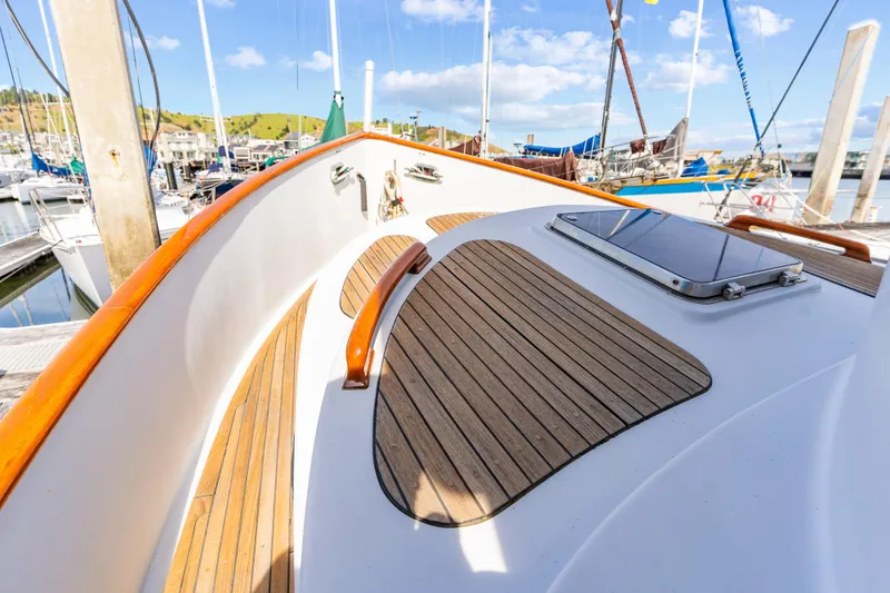 Slide: The Image of 1987 Lord Nelson 37 Victory Tug boat deck with wooden accents in marina. - 4