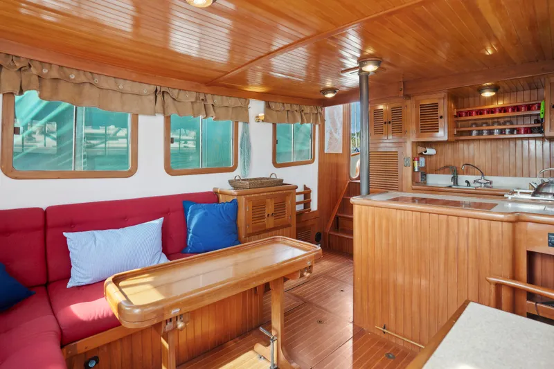 Slide: The Image of Interior of 1987 Lord Nelson 37 Victory Tug with wooden furnishings and cozy seating. - 8
