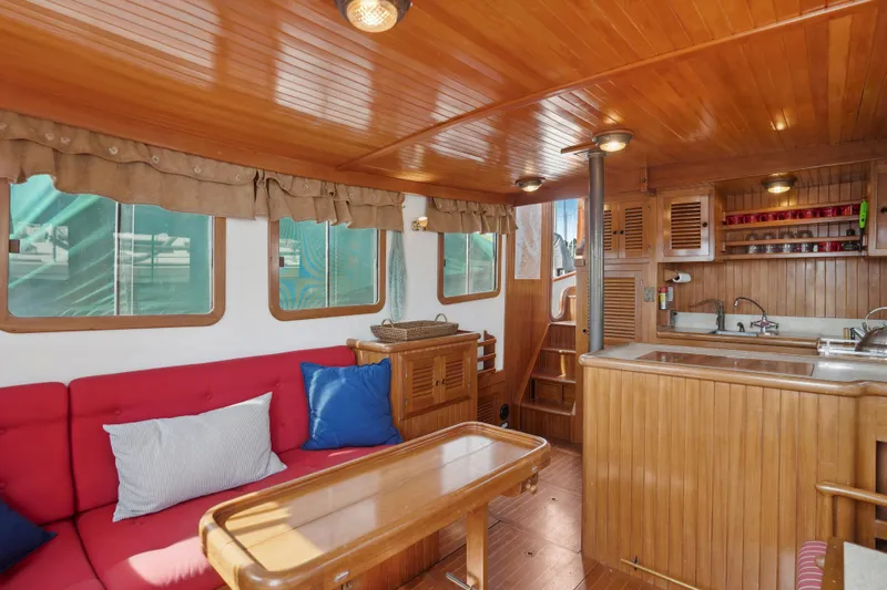 Slide: The Image of Cozy interior of 1987 Lord Nelson 37 Victory Tug with wood paneling and red seating. - 9