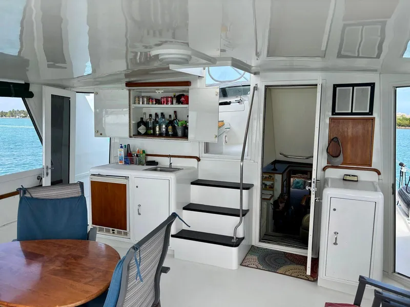 Slide: The Image of Interior of 1991 Hatteras 52 Cockpit Motor Yacht with seating and bar area. - 10
