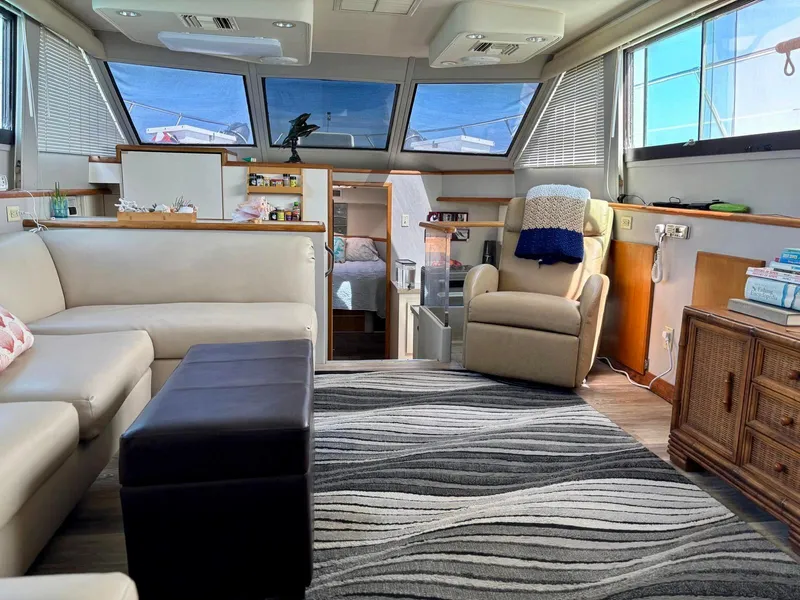 Slide: The Image of Interior of 1991 Hatteras 52 Cockpit Motor Yacht with modern furnishings and large windows. - 11