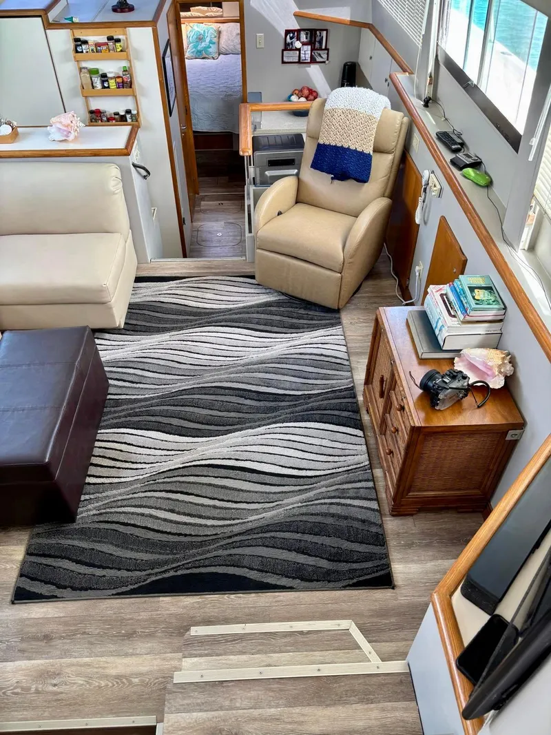 Slide: The Image of Interior of 1991 Hatteras 52 Cockpit Motor Yacht with modern decor and comfortable seating. - 12