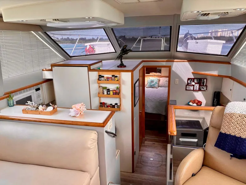 Slide: The Image of Interior of 1991 Hatteras 52 Cockpit Motor Yacht, featuring cozy seating and modern amenities. - 13