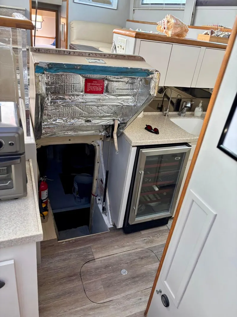 Slide: The Image of Interior of 1991 Hatteras 52 Cockpit Motor Yacht with kitchen and storage area. - 18