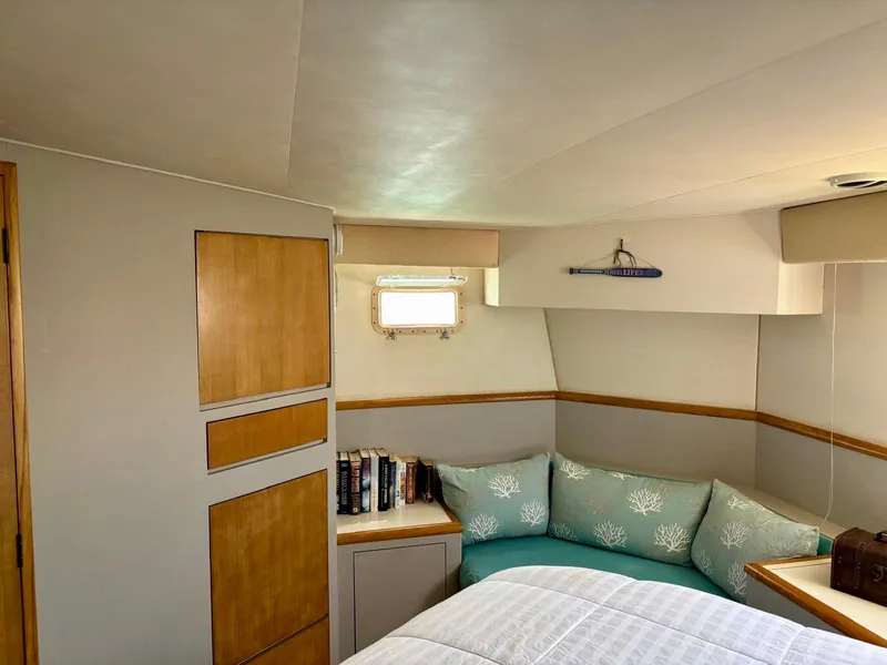 Slide: The Image of Cozy cabin interior of 1991 Hatteras 52 Cockpit Motor Yacht with books and cushions. - 20