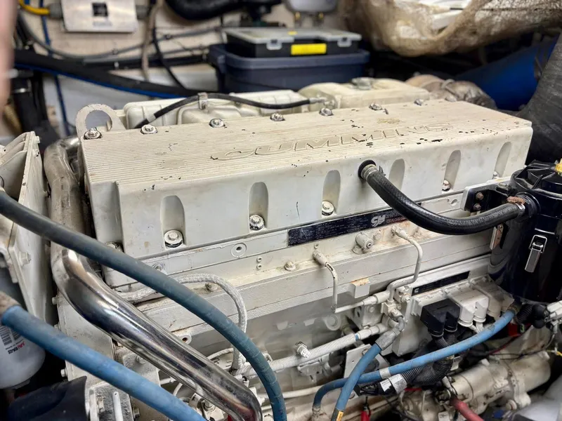 Slide: The Image of Engine compartment of a 1991 Hatteras 52 Cockpit Motor Yacht, featuring Cummins components. - 24