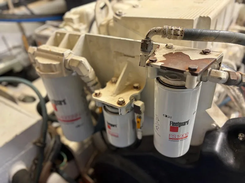 Slide: The Image of Engine components of a 1991 Hatteras 52 Cockpit Motor Yacht, featuring Fleetguard filters. - 26