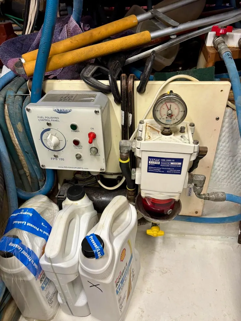 Slide: The Image of Engine room of 1991 Hatteras 52 Cockpit Motor Yacht with fuel filter and control panel. - 28