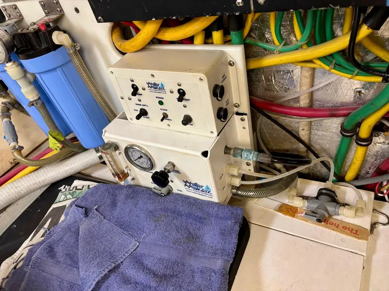 Slide: The Image of Engine room of 1991 Hatteras 52 Cockpit Motor Yacht with control panel and colorful wiring. - 29