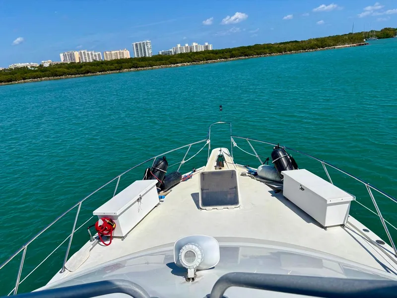 Slide: The Image of Bow view of 1991 Hatteras 52 Cockpit Motor Yacht on turquoise water. - 3