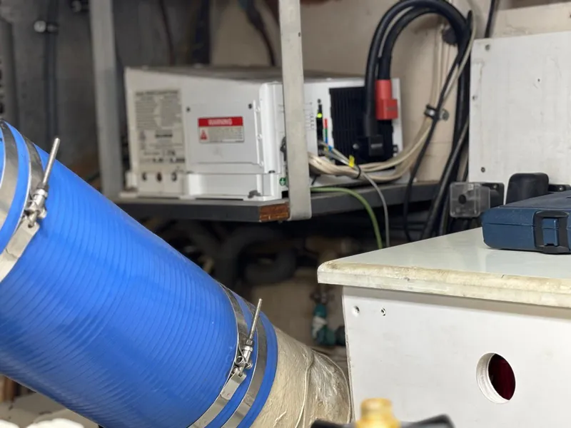 Slide: The Image of Engine room of 1991 Hatteras 52 Cockpit Motor Yacht with blue hose and electrical equipment. - 30