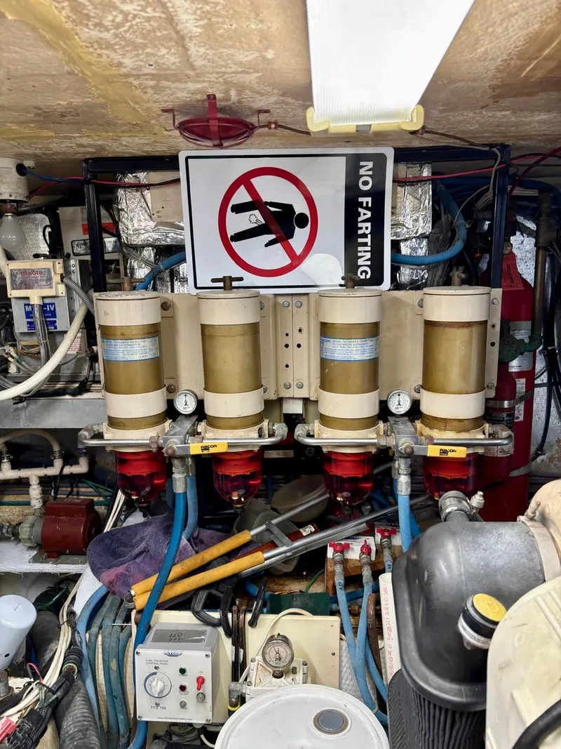 Slide: The Image of Engine room of 1991 Hatteras 52 Cockpit Motor Yacht with humorous "No Farting" sign. - 31