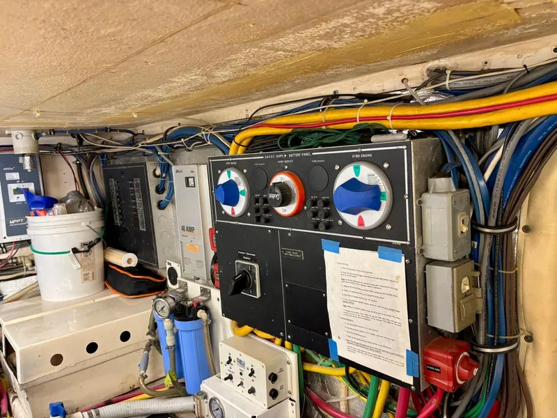 Slide: The Image of Engine room of 1991 Hatteras 52 Cockpit Motor Yacht with control panels and wiring. - 33