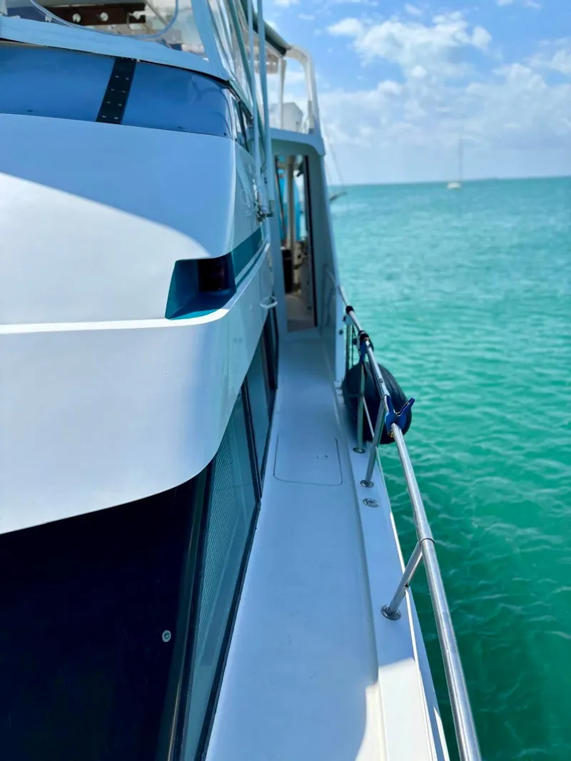 Slide: The Image of 1991 Hatteras 52 Cockpit Motor Yacht on turquoise water under blue sky. - 4