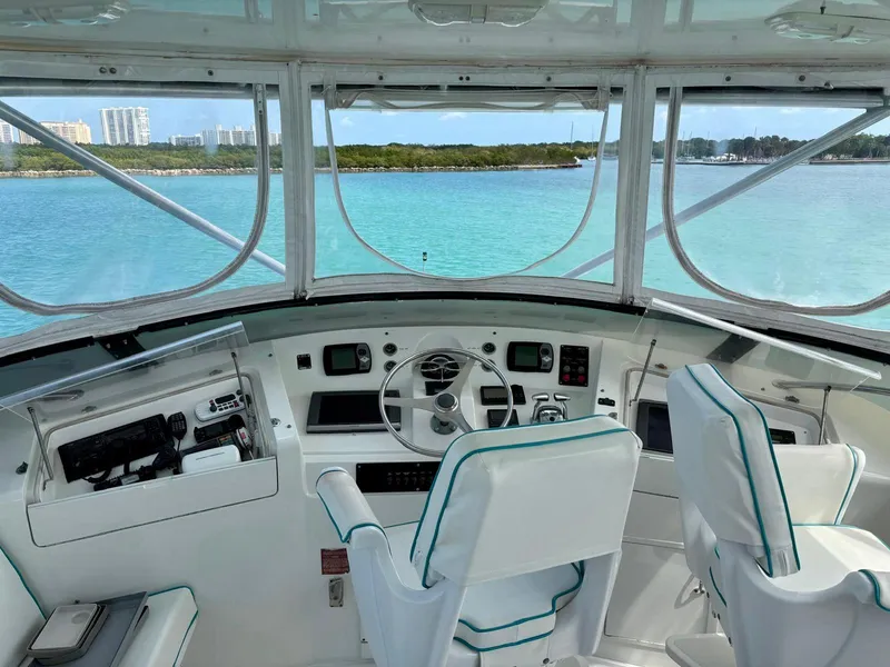 Slide: The Image of Cockpit view of 1991 Hatteras 52 Cockpit Motor Yacht on turquoise waters. - 6