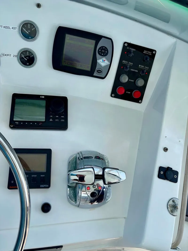 Slide: The Image of Control panel of a 1991 Hatteras 52 Cockpit Motor Yacht with gauges and navigation equipment. - 7