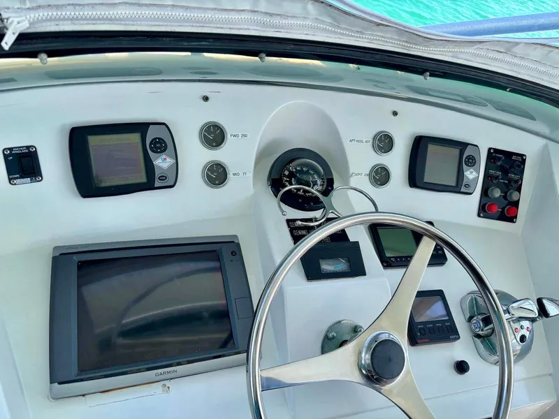 Slide: The Image of 1991 Hatteras 52 Cockpit Motor Yacht helm with navigation instruments and steering wheel. - 8