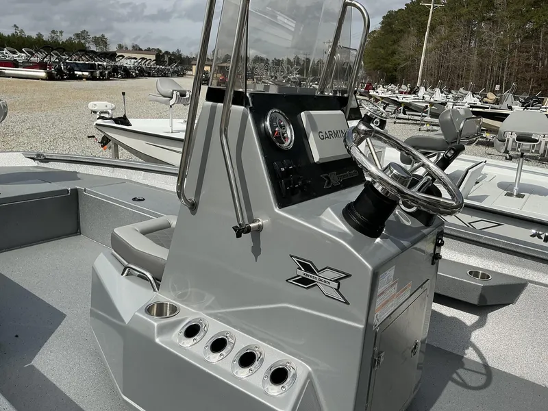 Slide: The Image of 2025 Xpress Hyper-Lift Series H22B boat console with steering wheel and controls. - 6