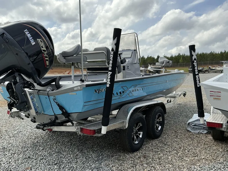 Slide: The Image of 2025 Xpress Hyper-Lift Series H22B boat on trailer, featuring Yamaha engine, parked outdoors. - 9