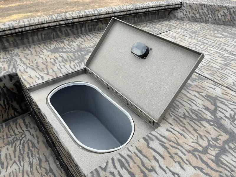 Slide: The Image of Open storage compartment on 2025 Xpress HD Series HD16DB boat with camouflage pattern. - 3