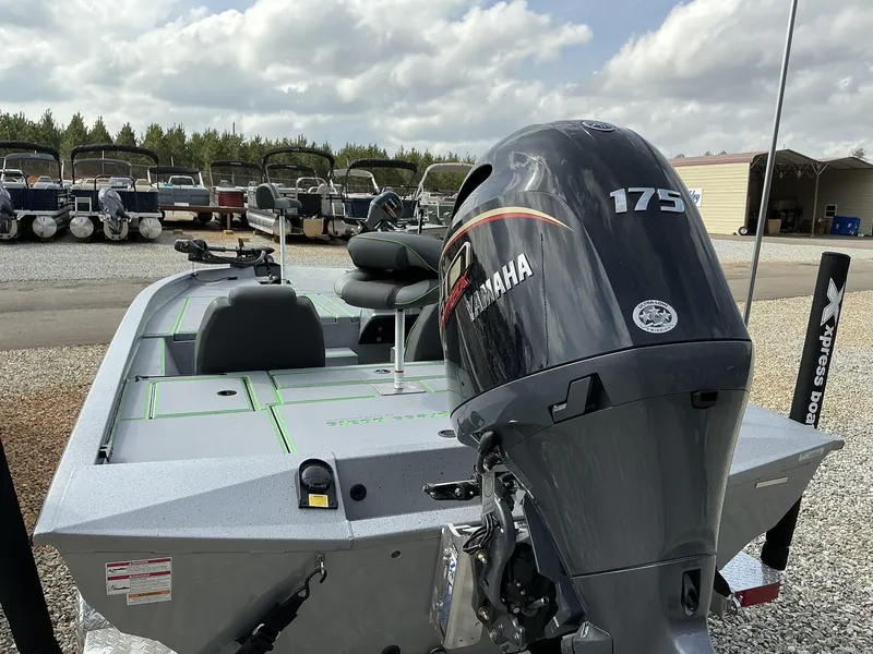 Slide: The Image of 2025 Xpress Hyper-Lift Bass Series boat with Yamaha 175 engine, parked outdoors. - 12