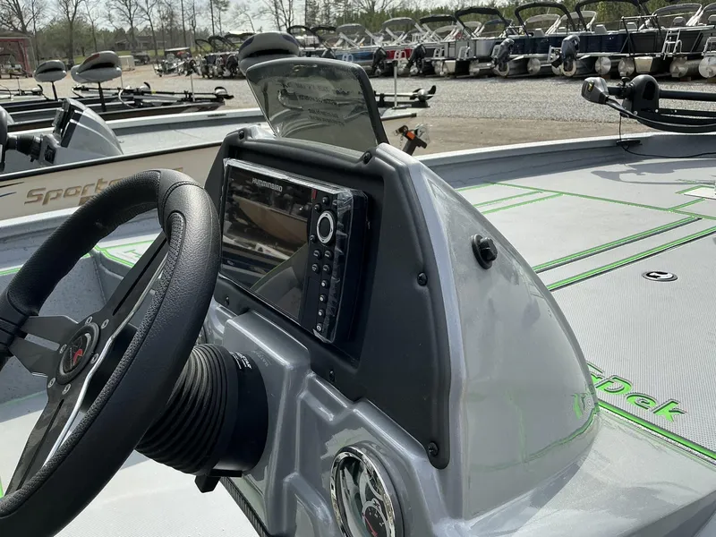 Slide: The Image of 2025 Xpress Hyper-Lift Bass Series boat dashboard with steering wheel and navigation system. - 5