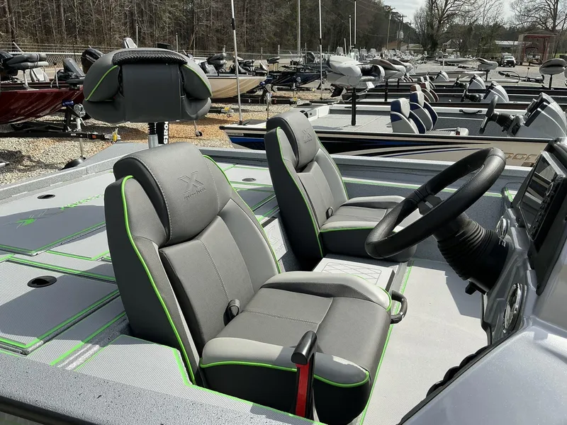 Slide: The Image of 2025 Xpress Hyper-Lift Bass Series boat interior with gray seats and green accents. - 8