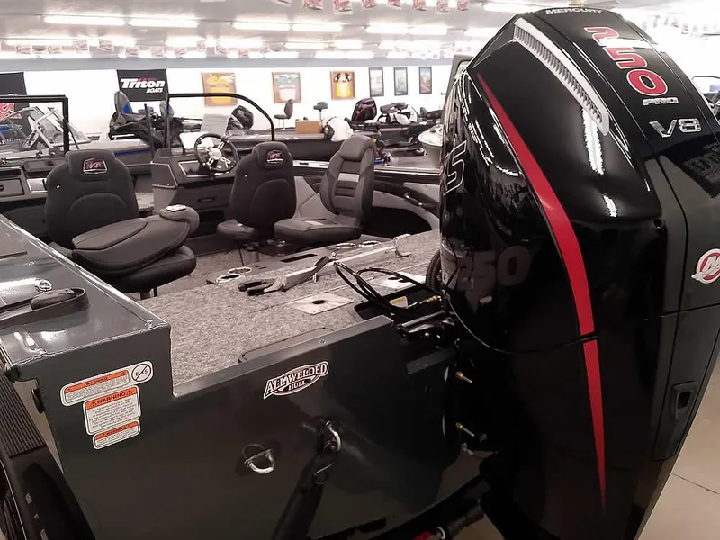 Slide: The Image of 2025 Ranger VX1988 WT boat with powerful V8 engine in showroom display. - 11