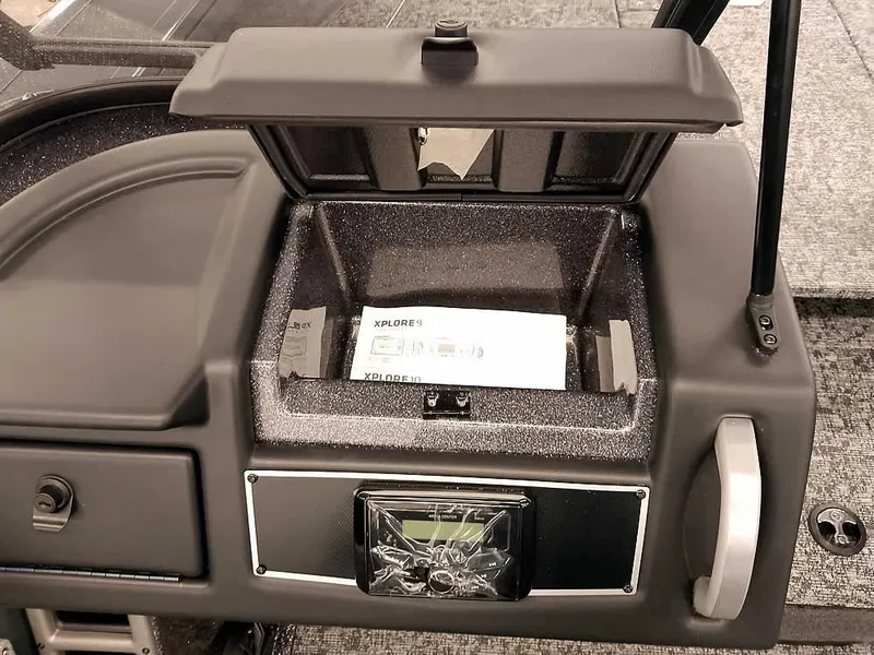 Slide: The Image of Dashboard of 2025 Ranger VX1988 WT boat with open storage compartment. - 26