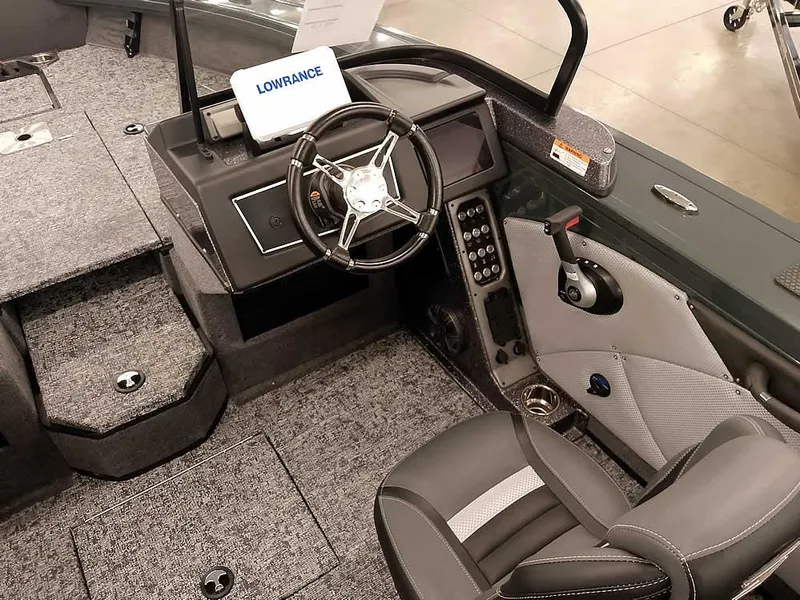 Slide: The Image of 2025 Ranger VX1988 WT boat interior with steering wheel, control panel, and Lowrance display. - 30