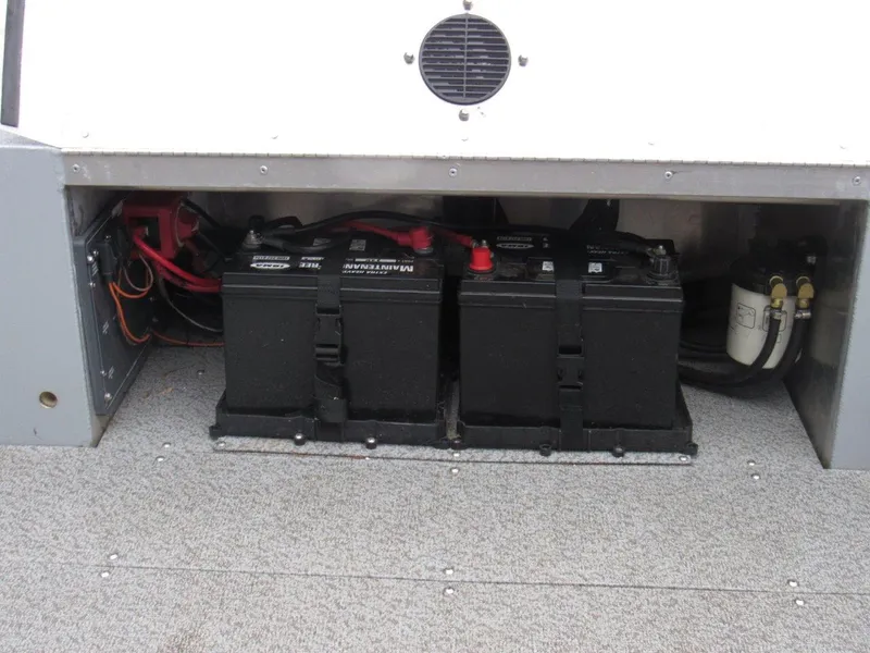 Slide: The Image of 2019 Hewescraft 200 Sportsman boat battery compartment with dual batteries and wiring. - 12