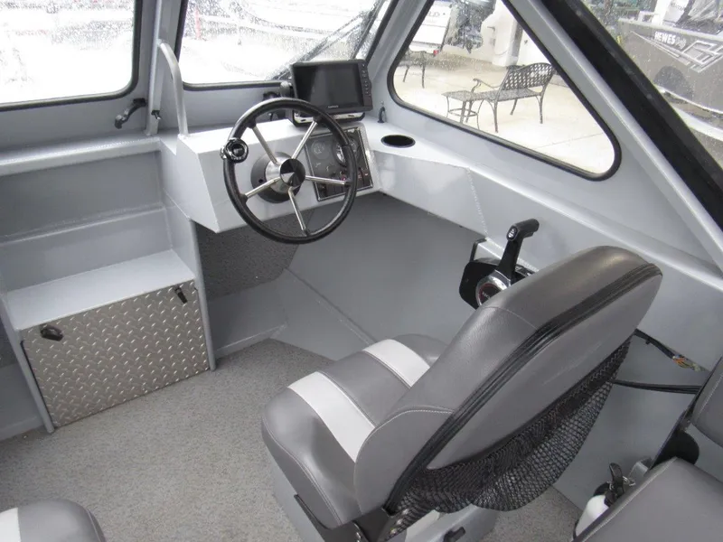 Slide: The Image of 2019 Hewescraft 200 Sportsman boat interior with steering wheel and control panel. - 13