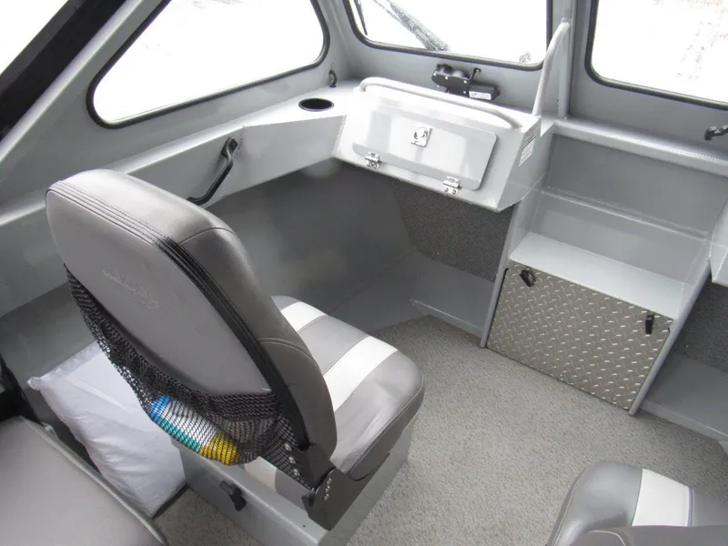 Slide: The Image of Interior of a 2019 Hewescraft 200 Sportsman boat with seating and storage compartments. - 14