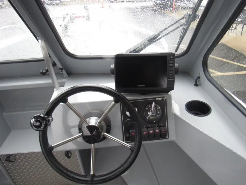 Slide: The Image of 2019 Hewescraft 200 Sportsman boat dashboard with steering wheel and navigation system. - 17