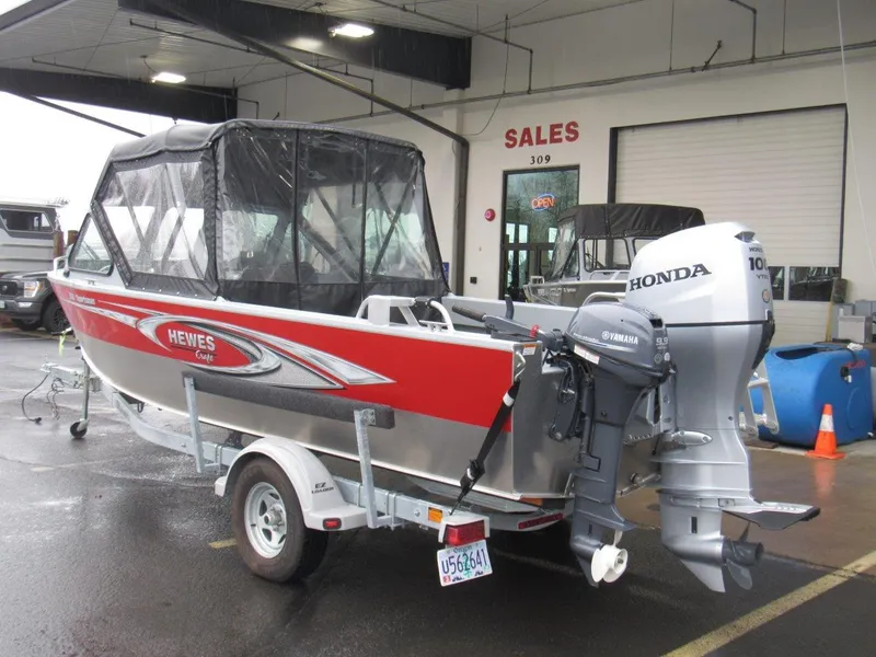 Slide: The Image of 2019 Hewescraft 200 Sportsman boat with Honda and Yamaha outboard motors in a sales showroom. - 3