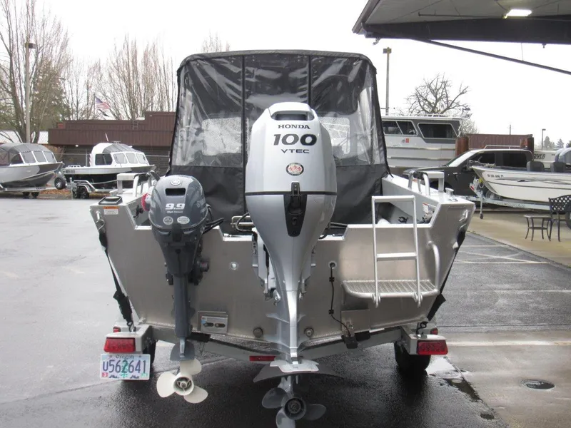 Slide: The Image of 2019 Hewescraft 200 Sportsman boat with Honda outboard motors in a marina setting. - 4