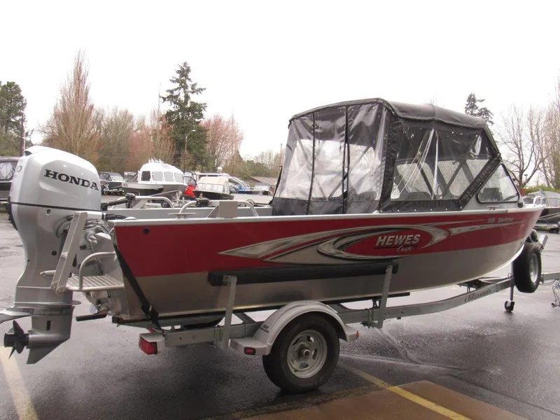 Slide: The Image of 2019 Hewescraft 200 Sportsman boat with Honda outboard motor, parked on a trailer. - 5