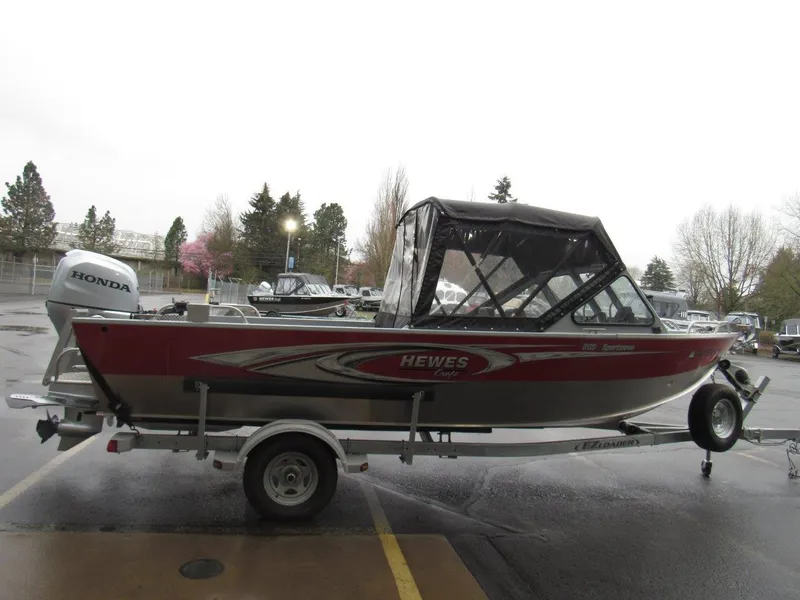 Slide: The Image of 2019 Hewescraft 200 Sportsman boat with Honda motor on a trailer in a parking lot. - 6