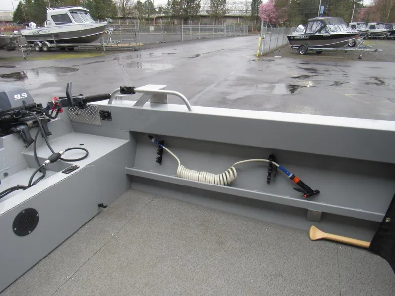 Slide: The Image of 2019 Hewescraft 200 Sportsman boat interior with motor and coiled hose. - 9