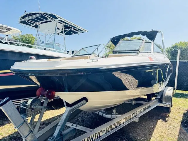 Slide: The Image of 2019 Sea Ray SPX 210 boat on trailer, parked outdoors. - 1