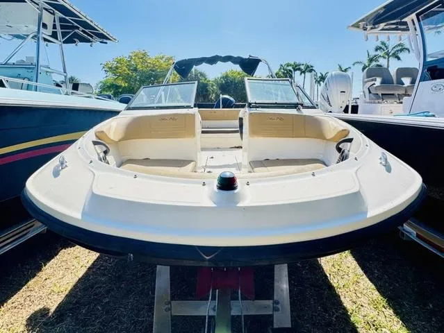 Slide: The Image of 2019 Sea Ray SPX 210 boat displayed outdoors, surrounded by other boats. - 2